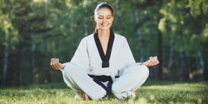 Martial Arts Lessons for Adults in Lewisville TX - Happy Woman Meditated Sitting Background